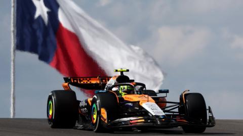 McLaren's Lando Norris during US Grand Prix practice with the flag of Texas in the background