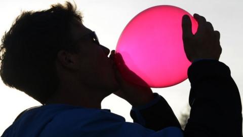 Man inhaling laughing gas