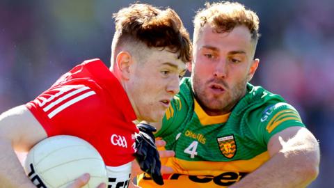 Derry's Lachlan Murray is tackled by Donegal defender Stephen McMenamin in the 2022 Ulster final