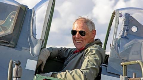 Tony Hughes sitting in an aircraft cockpit.