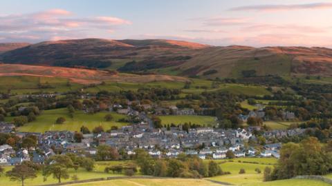 Aerial view of houses of Sedbergh among hills