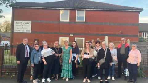 Acorn Lodge families gather outside the home