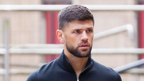 Joe Cordina, a man with brown hair and a brown beard. He's wearing a navy quarter-zip.