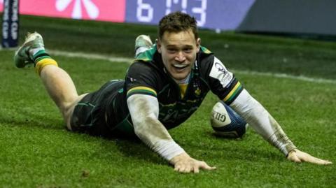 Tom Seabrook lands on all fours after diving over the line for a try for Northampton Saints