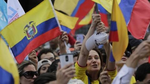 Supporters cheer on CREO"s presidential candidate Guillermo Lasso outside the Electoral National Council, in Quito, Ecuador, Tuesday, Feb. 21, 2017