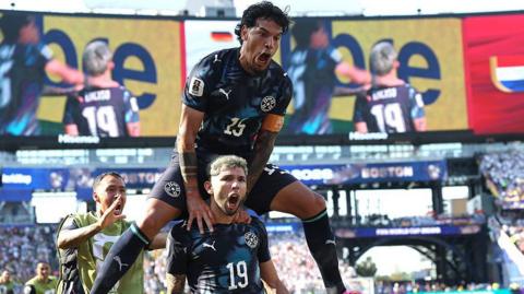 ulio Enciso Paraguay celebrates with teammate Gustavo Gomez after scoring his team's first goal during the FIFA World Cup 2026 Round Of 32 match between Germany and Paraguay at Boston Stadium in Foxborough, Massachusetts