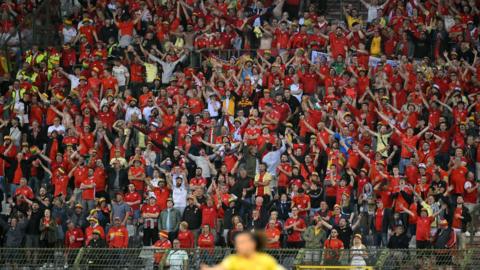 Wales supporters cheer their team on from the stands during the FIFA World Cup 2026 Group J European qualification football match between Belgium and Wales in Brussels, on June 9, 2025