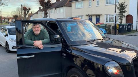 Kevin Paul, with his taxi