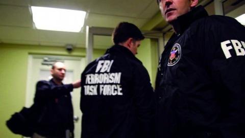 FBI Special Agents and members of the Joint Terrorism Task Force prepare to arrest a suspect