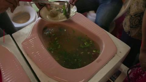 A toilet bowl serving food at Jamban Cafe