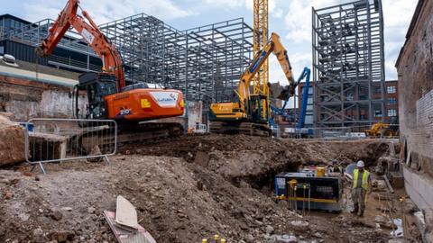 Two diggers work on demolition of old industrial and factory buildings to make way for housing in Birmingham