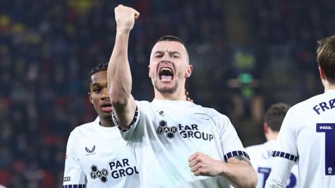 Preston striker Milutin Osmajic punches the air to celebrate his second goal against Watford