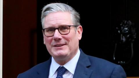 Keir Starmer in a navy suit.