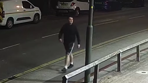 An image of Paul Jinks walking through a street in Long Eaton whilst stalking a woman