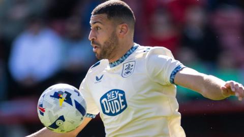 Radinio Balker controls the ball for Huddersfield against Leyton Orient in April.