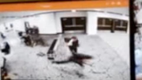 Surveillance video released by Donald Trump shows the suspect running past metal detectors as security agents draw their guns.