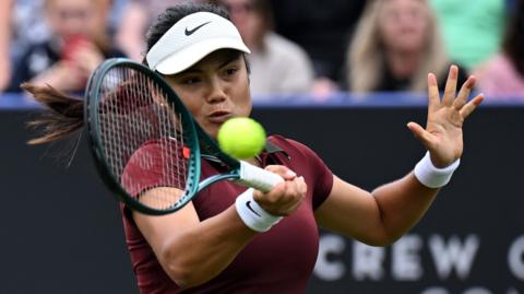 Emma Raducanu hits a forehand