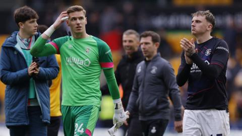 Luton players look dejected after defeat at Wolves