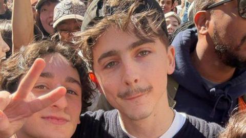 Timothée Chalamet (C) poses with a lookalike at a contest in New York