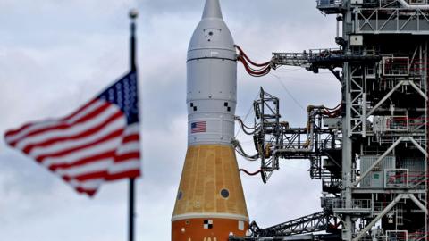 Artemis II and an American flag