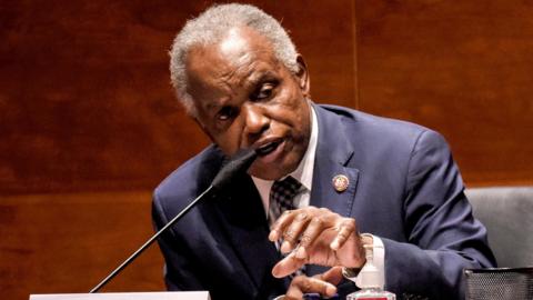 US Representative wears a dark suit and leans over to speak into a table microphone during a hearing of the House of Representatives' Financial Services Committee on 30 June 2020.