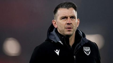 Oxford United manager Matt Bloomfield looks on from the sidelines 