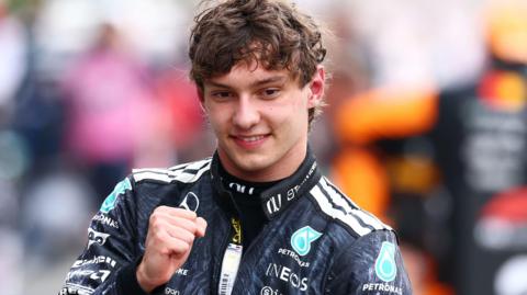 Kimi Antonelli smiles and clenches his fist in celebration after winning the Japanese Grand Prix