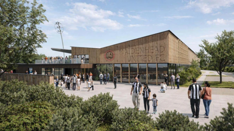 A CGI image of Maidenhead United's potential new stadium, showing people milling outside it. It appears to have an open terrace with people meeting and wooden cladding on the outside at the top of a small stand, with windows beneath it.