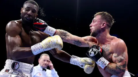 Shakiel Thompson is punched by Brad Pauls