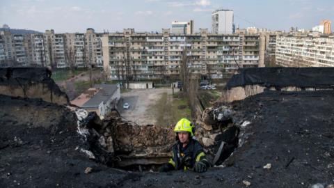 Firefighter at damaged building in Kyiv