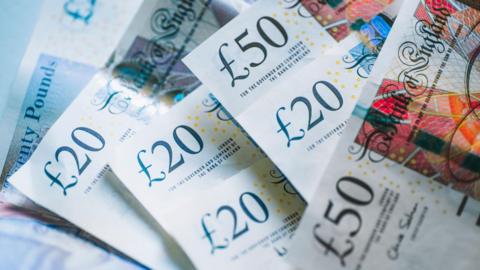 Stock image of £20 and £50 notes.