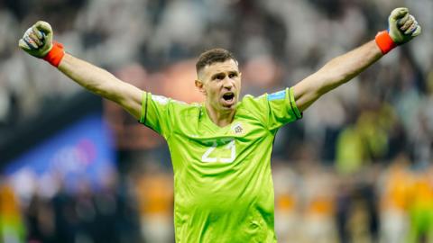 Emiliano Martinez celebrates with his arms outstretched