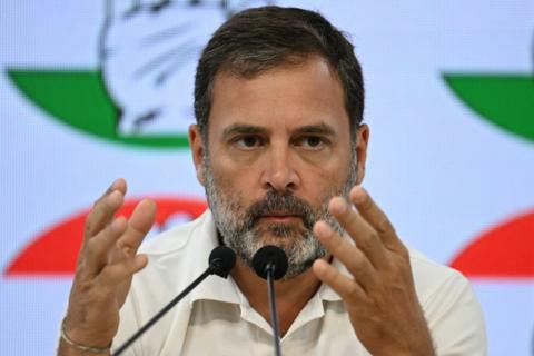 Rahul Gandhi, wearing a white shirt, addresses a press conference