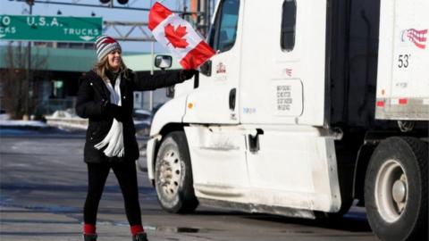 A woman attends the protest at the Ambassador Bridge