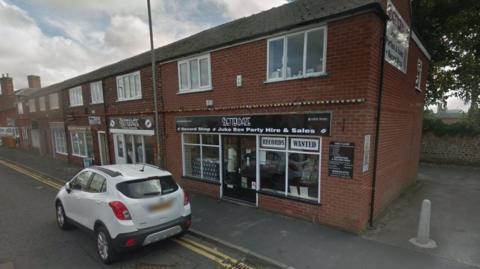 The outside of the Betterdaze record shop in Northallerton, a small white car is parked outside 