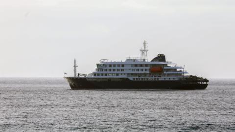 A ship sails on a body of water