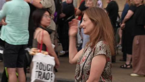 Deborah Prentice is part of a crowd at a vigil in Cambridge