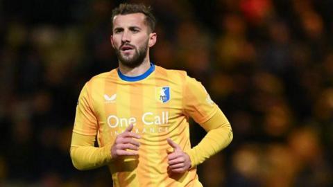Close up of Mansfield Town defender Baily Cargill running during a match