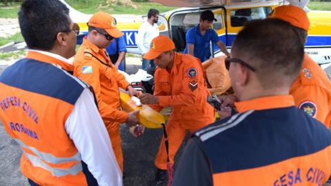 Picture shows rescue team preparing to search for pilot's body