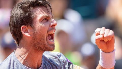 Cameron Norrie roars in celebration during his French Open win against Benoit Paire