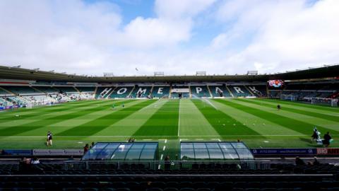 A view of the Home Park stadium. The pitch is green and you can see the stands surrounding the grounds.