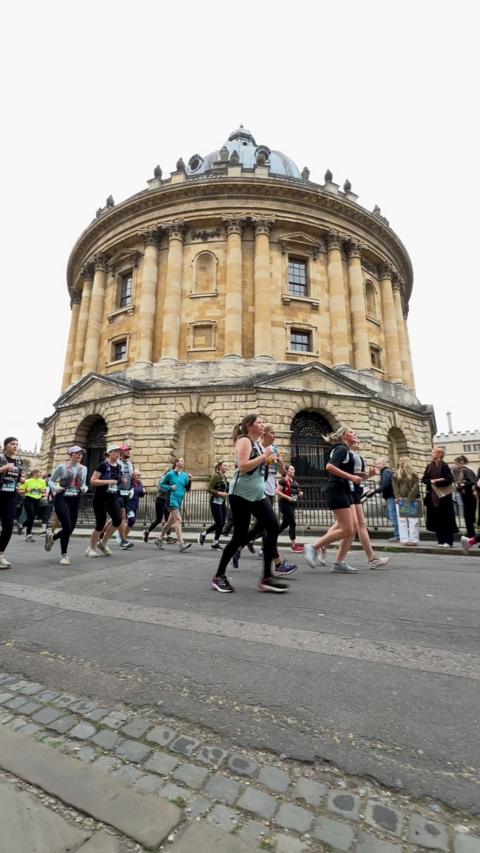 Oxford Half Marathon runners go past the Radcliffe Camera