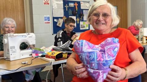 Julie Wood with one of the cushions for people with breast cancer