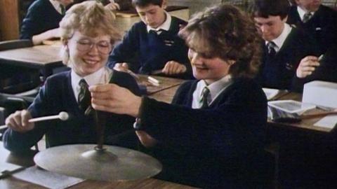 Secondary school pupils playing instruments in a music class.