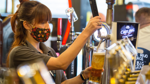 A woman pulls a pint