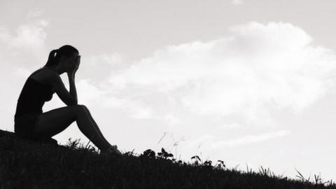 Unhappy teenage girl in silhouette