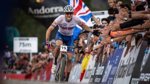 Charlie Aldridge "high fives" the crowd while competing for GB