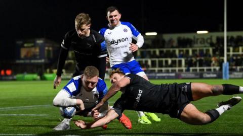 Finn Russell diving over the Newcastle try line to score for Bath.