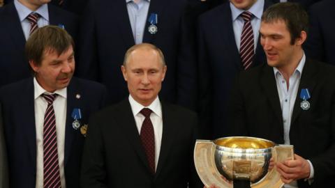 Russian President Vladimir Putin (centre) with trainer Oleg Znarok (left), Alexander Ovechkin (right) and other Russian ice hockey team players who won the 2014 World Championship