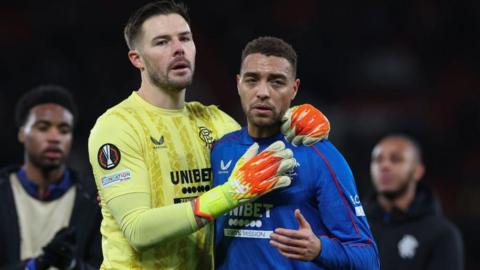 Jack Butland of Rangers and Cyriel Dessers of Rangers are seen at full time during the UEFA Europa League 2024/25 League Phase MD7 match between Manchester United and Rangers FC at Old Trafford on January 23, 2025 in Manchester, England. 